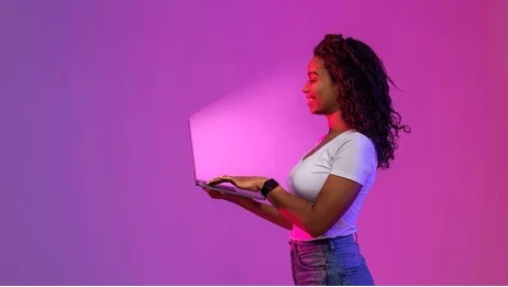 smiling-black-woman-holding-laptop-260nw-2265476713